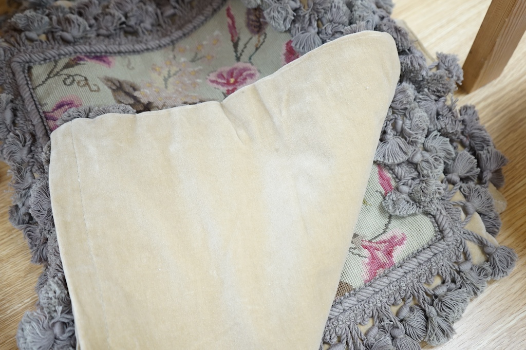 Six small wool worked rectangular cushion covers, designed with roses and trailing flowers on a pale green ground, with mushroom tasselled fringing and velvet backs. 30cm wide x 26cm high. Condition - unused